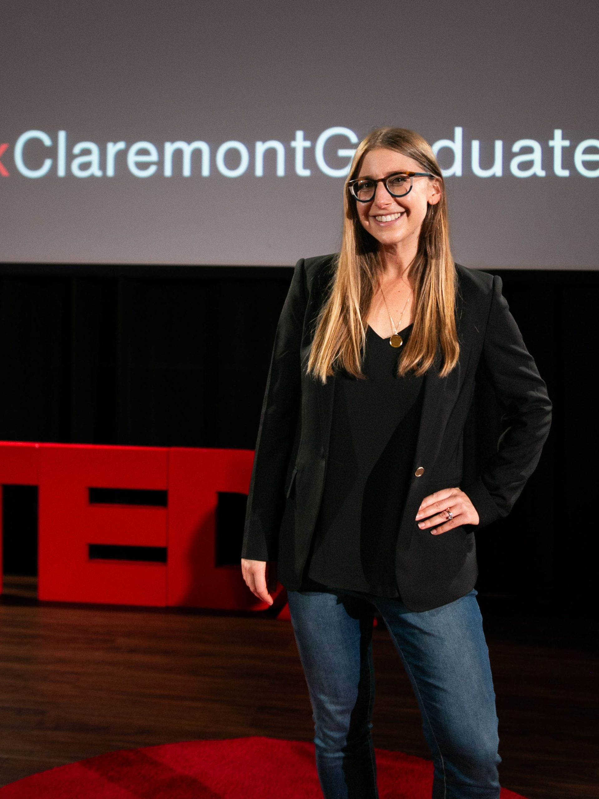 alyssa standing in front of TEDx sign